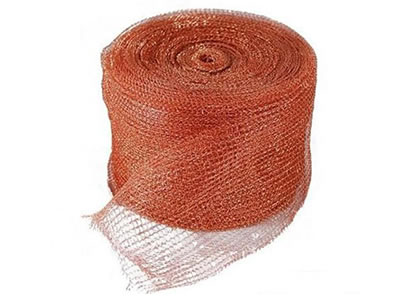 A roll of copper knitted wire mesh on the white background.