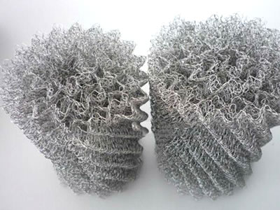 Two ginning knitted wire meshes on the gray background.