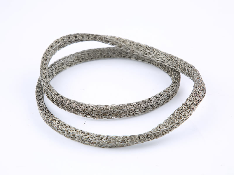A roll of knitted mesh gasket on the white background.