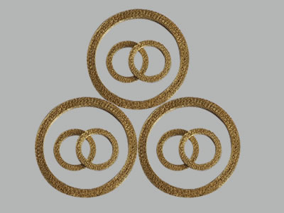 Nine Brass compressed knitted mesh gaskets on the gray background.