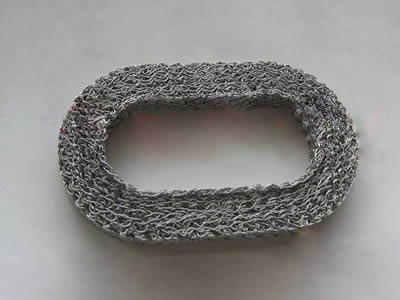 A oval shape compressed knitted mesh on the white background.