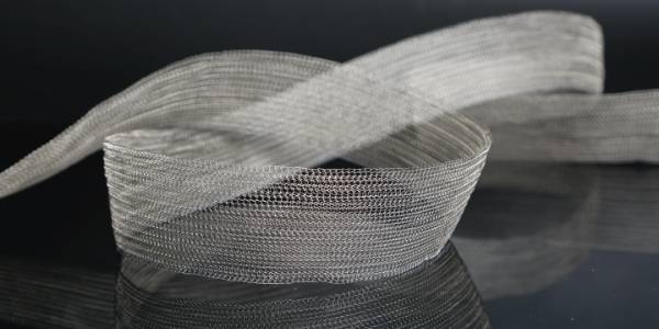 Curved knitted mesh is placed on the ground.