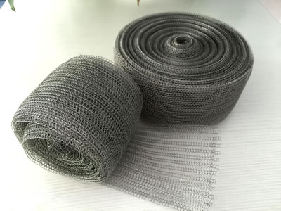 Two rolls of knitted mesh fabrics on the table.
