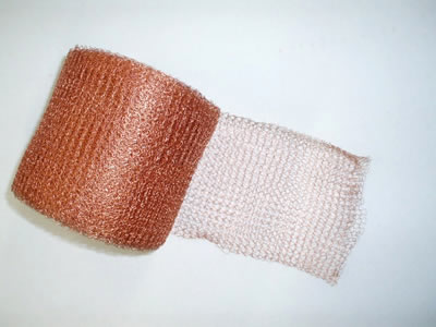 A copper knitted wire mesh on the white background.