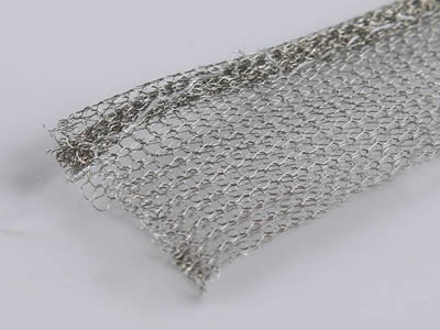 A round with tail shape knitted wire mesh gasket on the gray background.