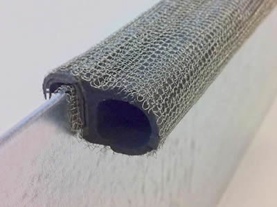 A knitted wire mesh gasket is installed onto the shielding panel.
