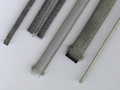 Several knitted wire mesh gaskets on the gray background.