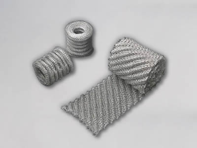 A roll and an unpacked ginning knitted wire mesh tape on the white background.
