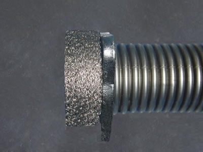 A knitted wire muffler is installed on the exhaust pipe.