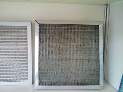 Two stainless steel wire mesh filter panel on the shelf.