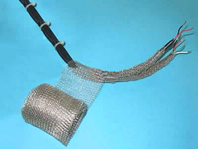 A roll of stainless steel knitted mesh is twining a cable.